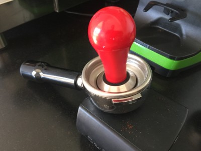 Tamper past in bakje, daardoor kun je de koffie goed in het midden aandrukken